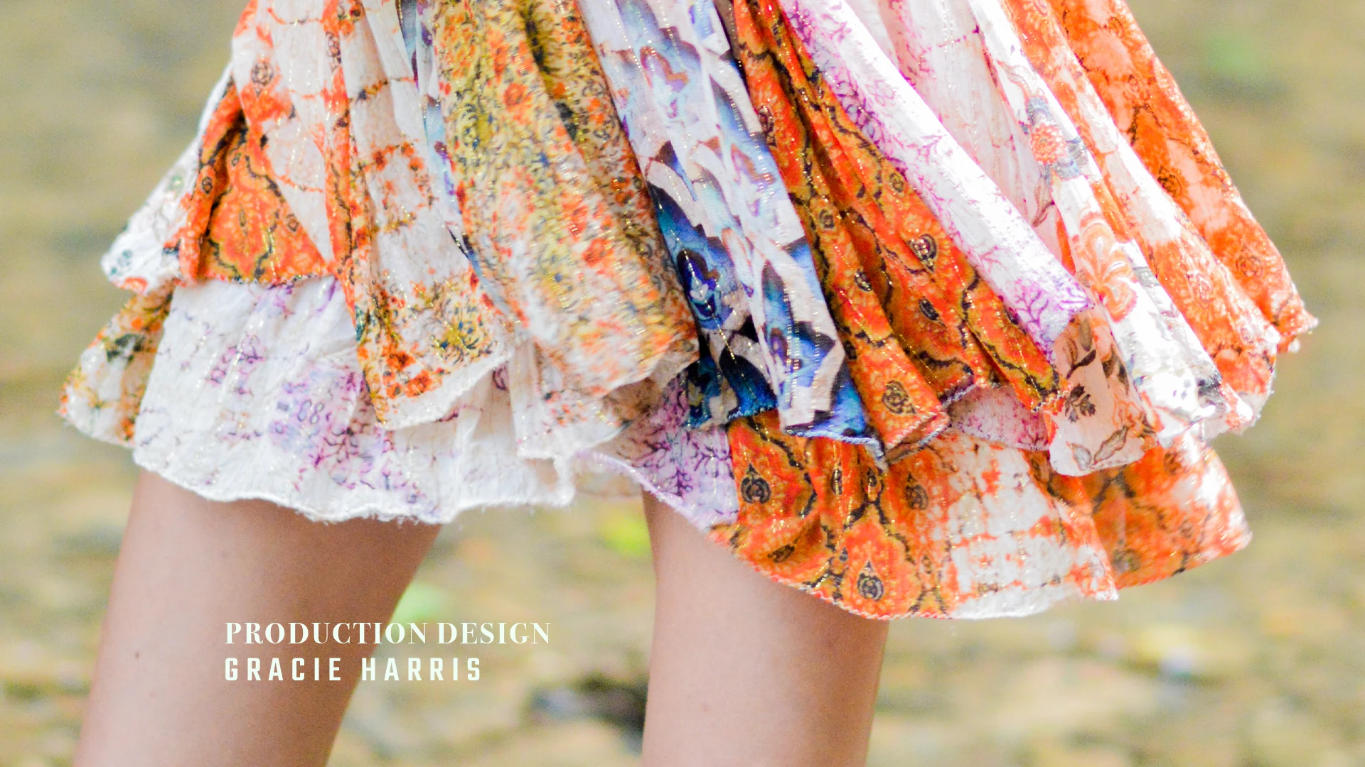 A colorful patterned dress with a production design credit