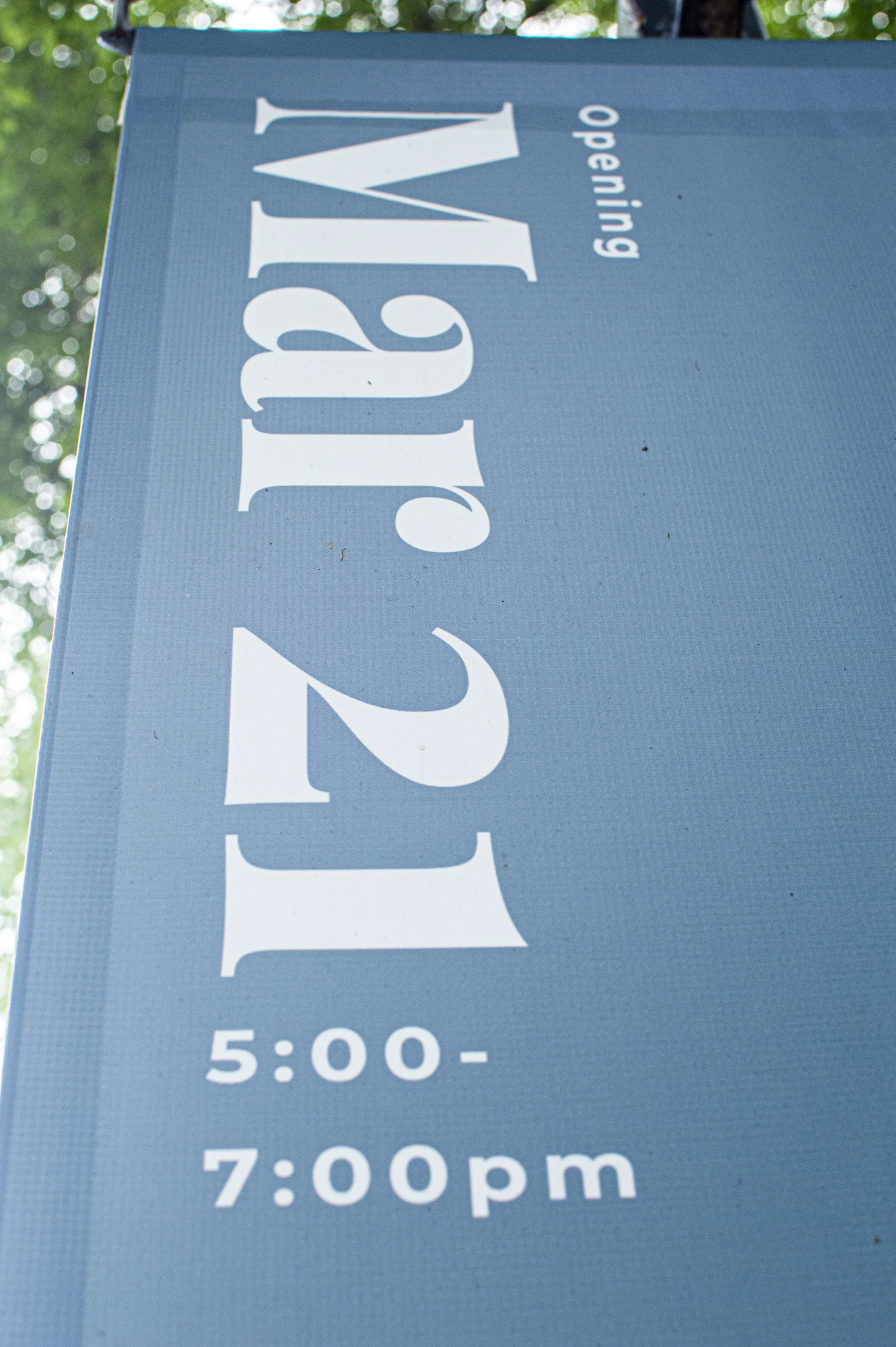 Close-up of exhibition date typography on a gallery banner