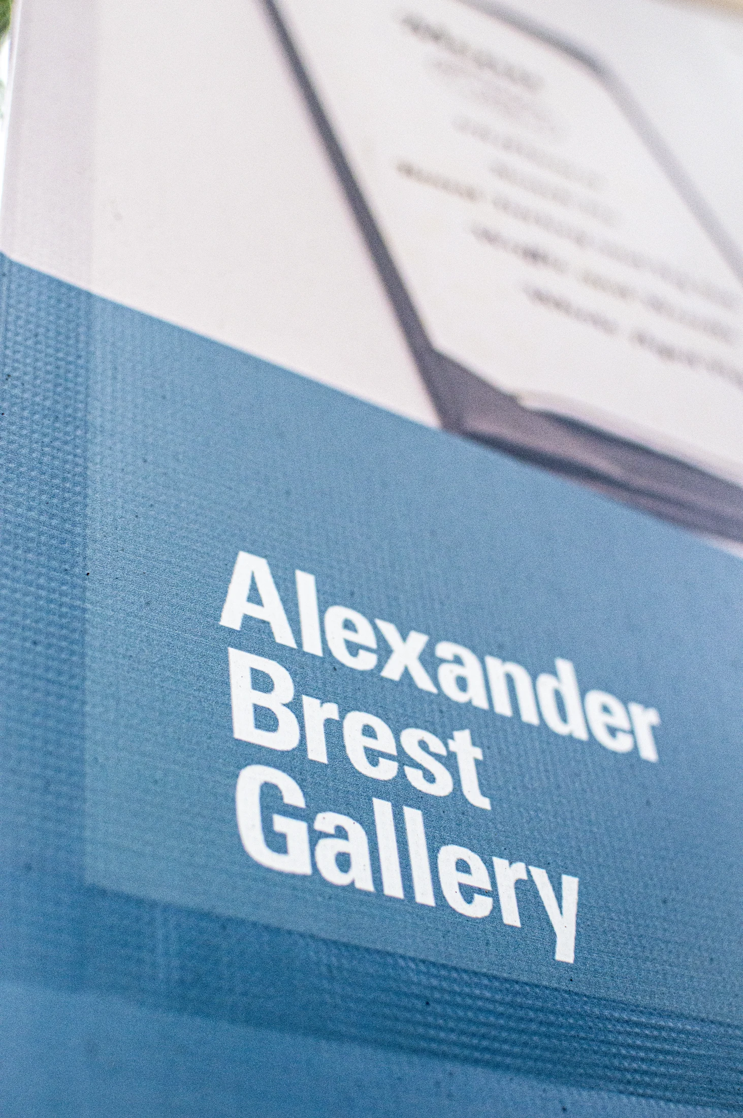Alexander Brest Gallery lettering on a blue banner